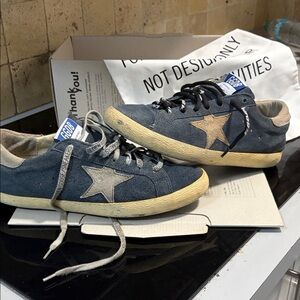Golden Goose navy suede sneakers with yellow soles